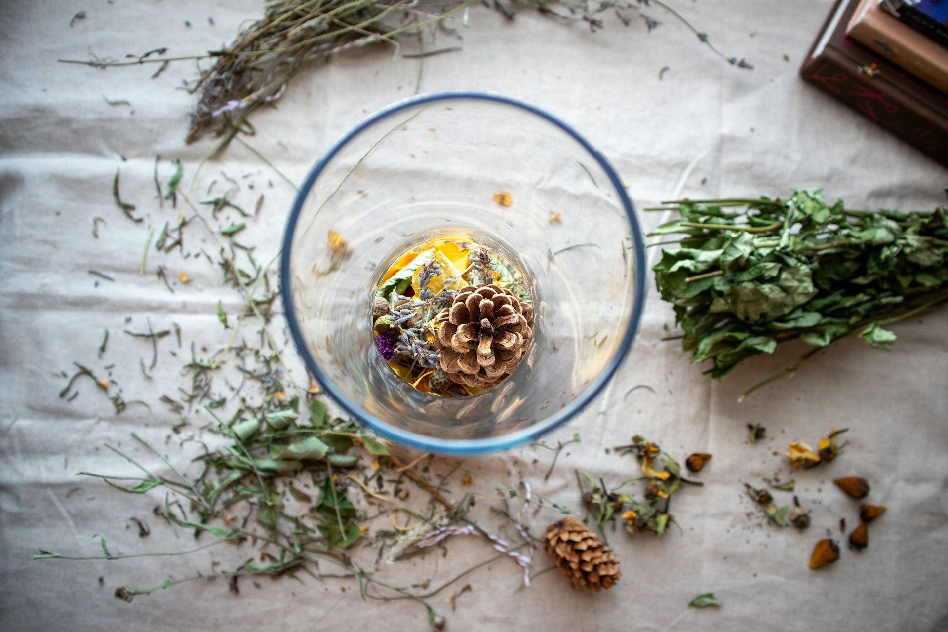 Dried herbs and rose petals in a glass bowl
